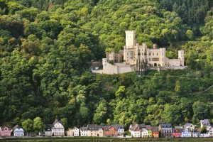 tolzenfels Castle near Koblenz and lined colored houses at the river bank of the Rhine, Upper Middle Rhine Valley, Germany